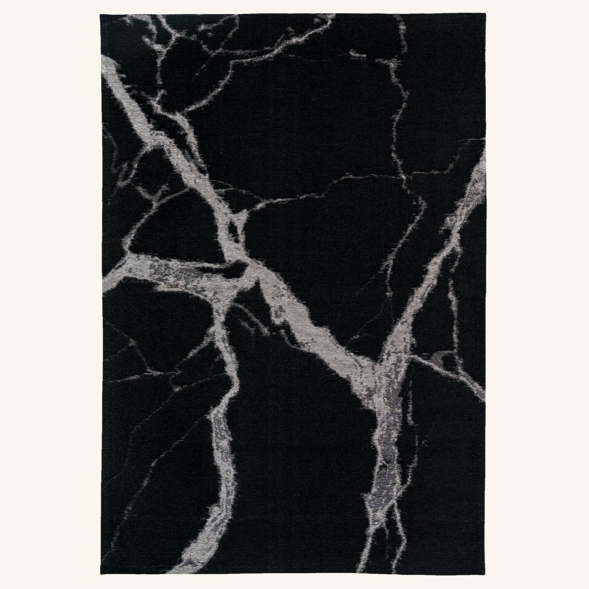 Tapis lavable effet pierre noir - Zarossa - fond #F9F6F0 détouré